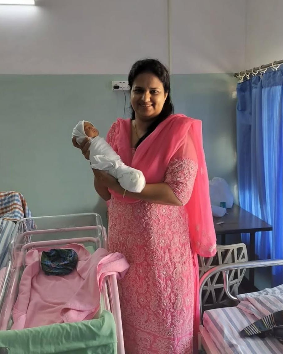 Dr. Sharon with newborn baby in maternity ward